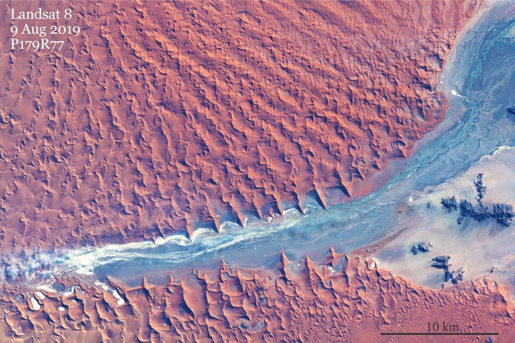 Modern sedimentary basin fill – the Namib dune sea (Namibia), where dunes as high as 300-400m border a salt flat and ephemeral streams. About 50 km east of the Atlantic coast. Image credit: USGS, Landsat 8