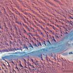 Modern sedimentary basin fill – the Namib dune sea (Namibia), where dunes as high as 300-400m border a salt flat and ephemeral streams. About 50 km east of the Atlantic coast. Image credit: USGS, Landsat 8