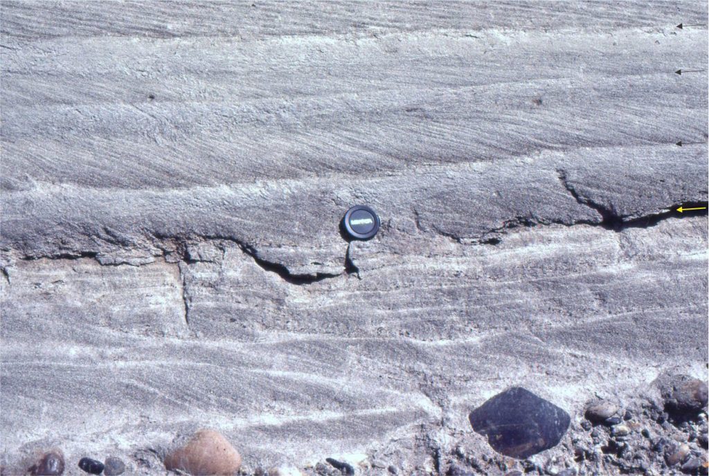 Stacked tabular crossbeds above the lens cap, and trough crossbeds below, indicating subtle but important changes in flow velocity. Foreset contacts vary from abrupt to tangential. Flow was to the right. Paleocene Summit Creek Fm. McKenzie River.